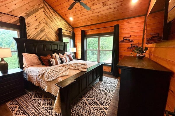 Trout Creek Mountain Oasis cabin exterior glowing at night under a Milky Way sky, Ellijay GA
